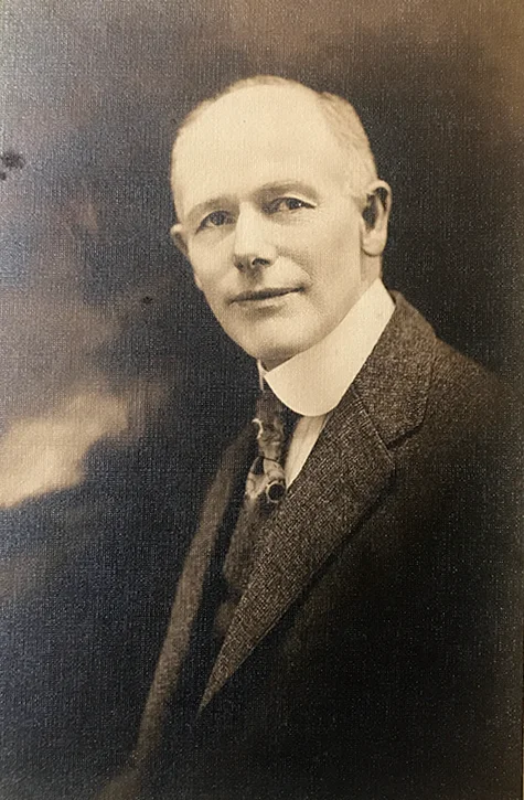 Portrait of Mark Shrum in a suit and tie, early 1900s studio photograph.