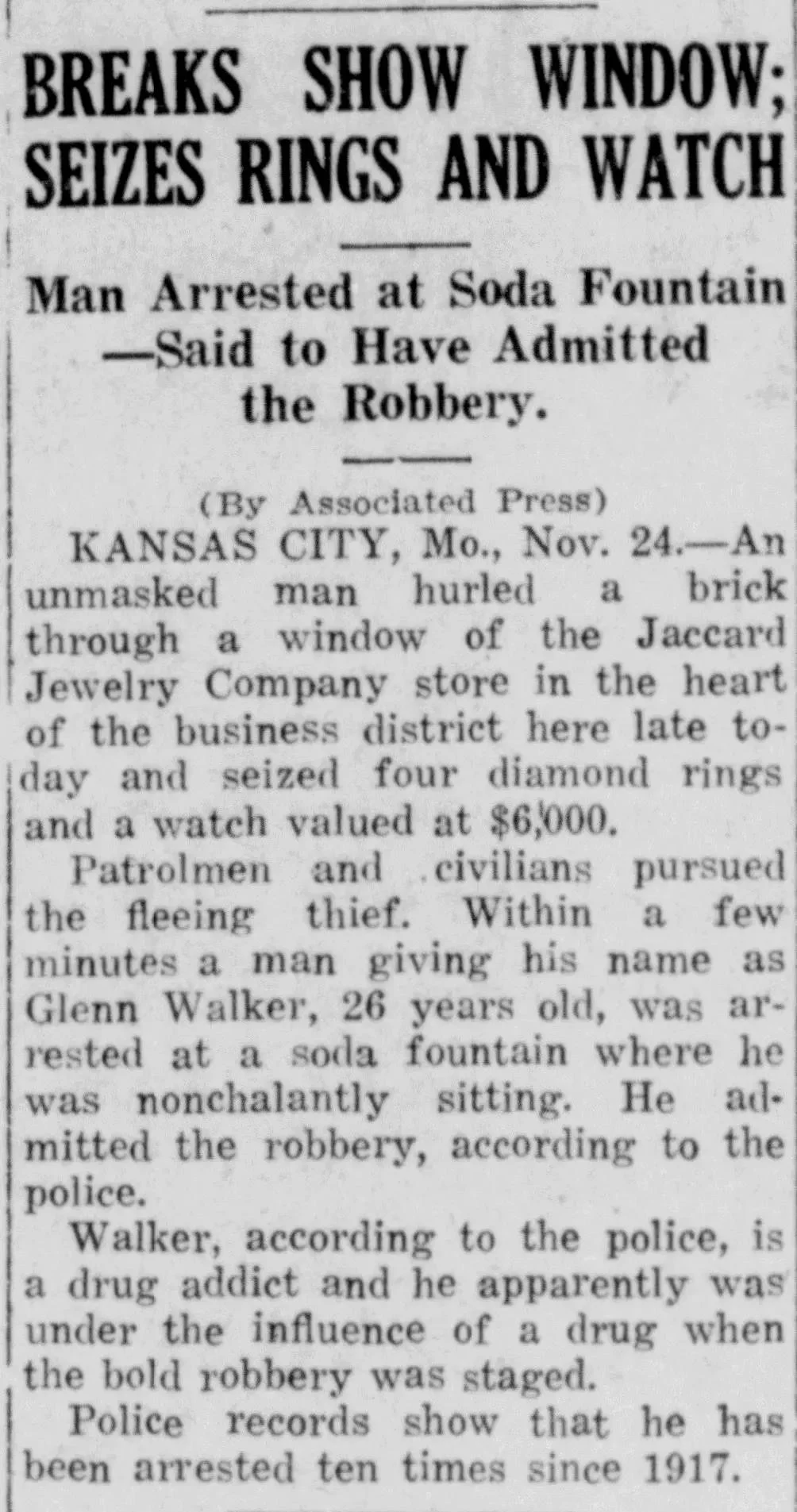 Historical newspaper clipping from the Jefferson City Daily Capital News with the headline “Breaks Show Window; Seizes Rings and Watch,” reporting the arrest of Glenn Walker after the Kansas City jewelry store robbery.