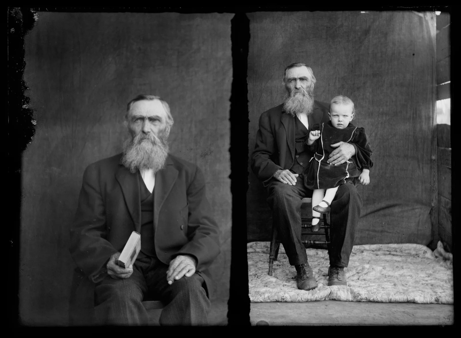Unidentified elderly man photographed alone and holding a young child, early 20th century portrait