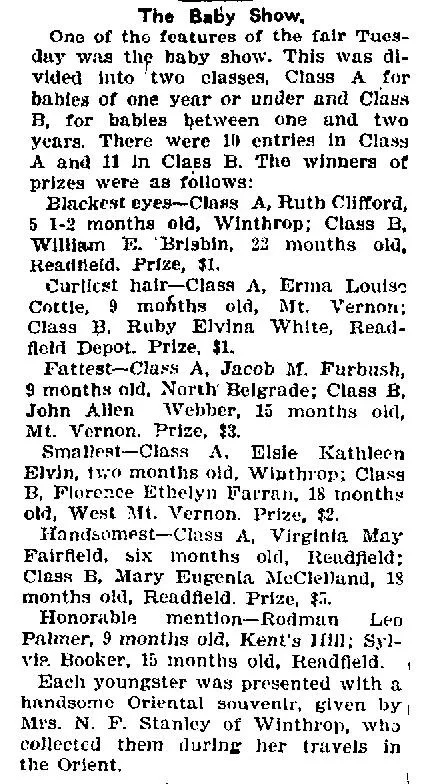 Newspaper clipping headlined "The Baby Show" from the Daily Kennebec Journal, reporting 21 entries across two age classes and listing winners by category — blackest eyes, curliest hair, fattest, smallest, and handsomest — with each infant's name, age in months, and hometown, and noting all received an Oriental souvenir collected by Mrs. N. F. Stanley of Winthrop during her travels.